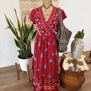 Red floral maxi wrap dress with adjustable wrap design and tie waist.